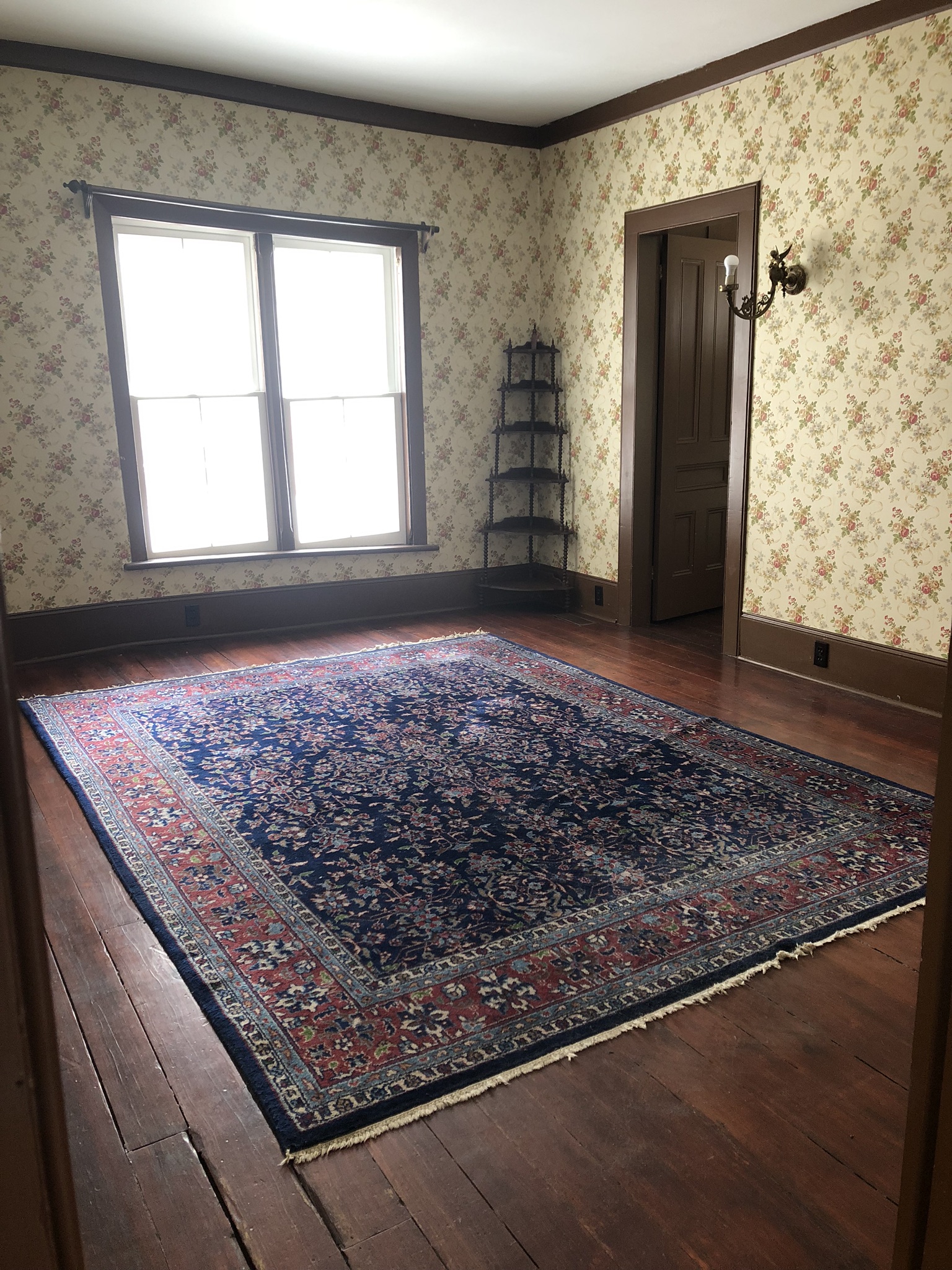 Image of master bedroom with floor rug and corner shelves